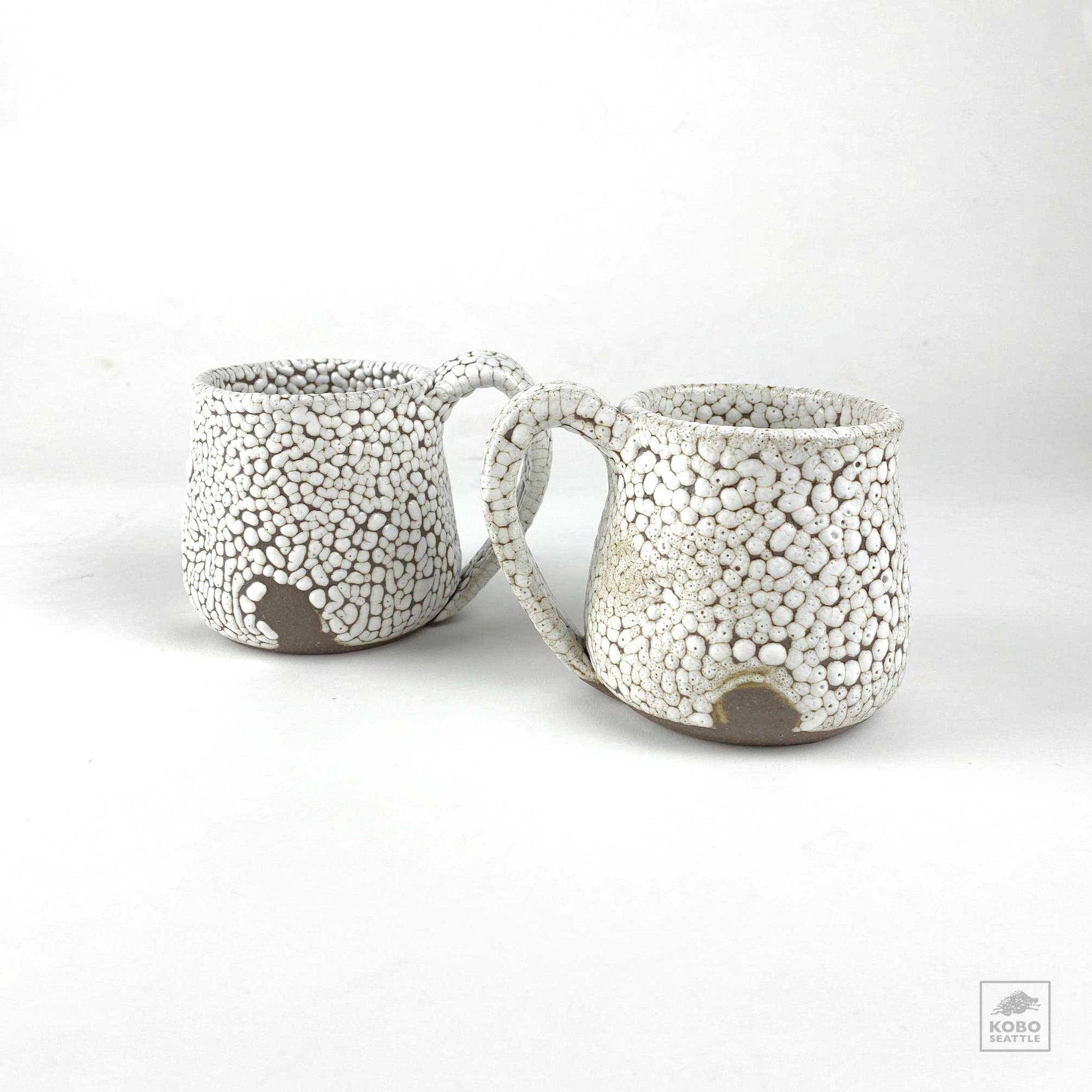 Dark Clay with White Mugs by Brendan Fuller