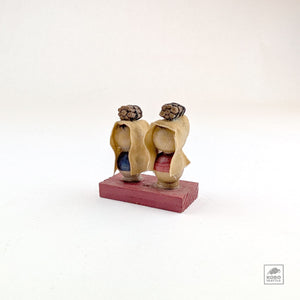 Vintage Kokeshi Pair on Red Platform