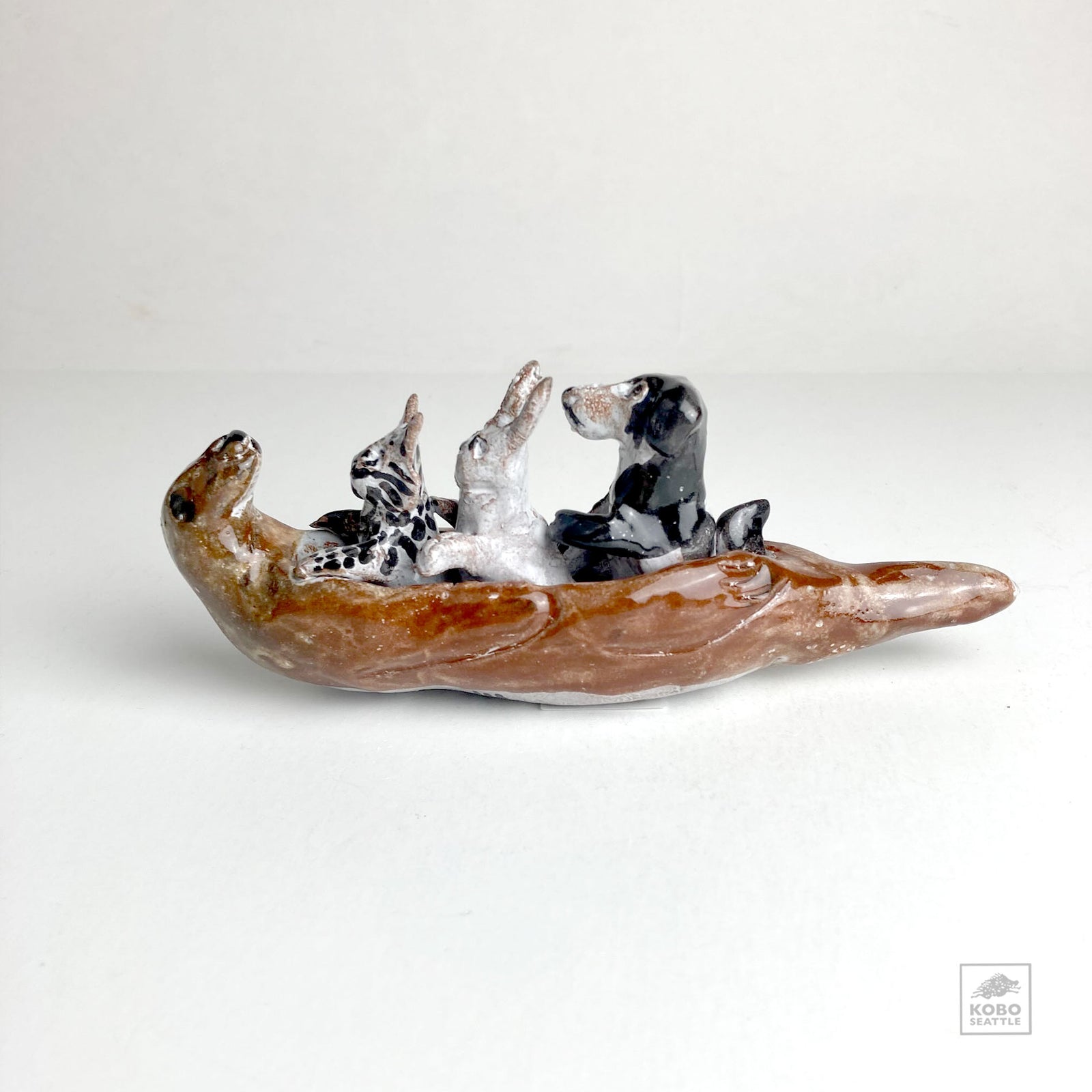 Cat, Rabbit, and Dog in Otter Canoe by Aaron Murray