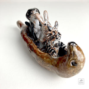 Cat, Rabbit, and Dog in Otter Canoe by Aaron Murray